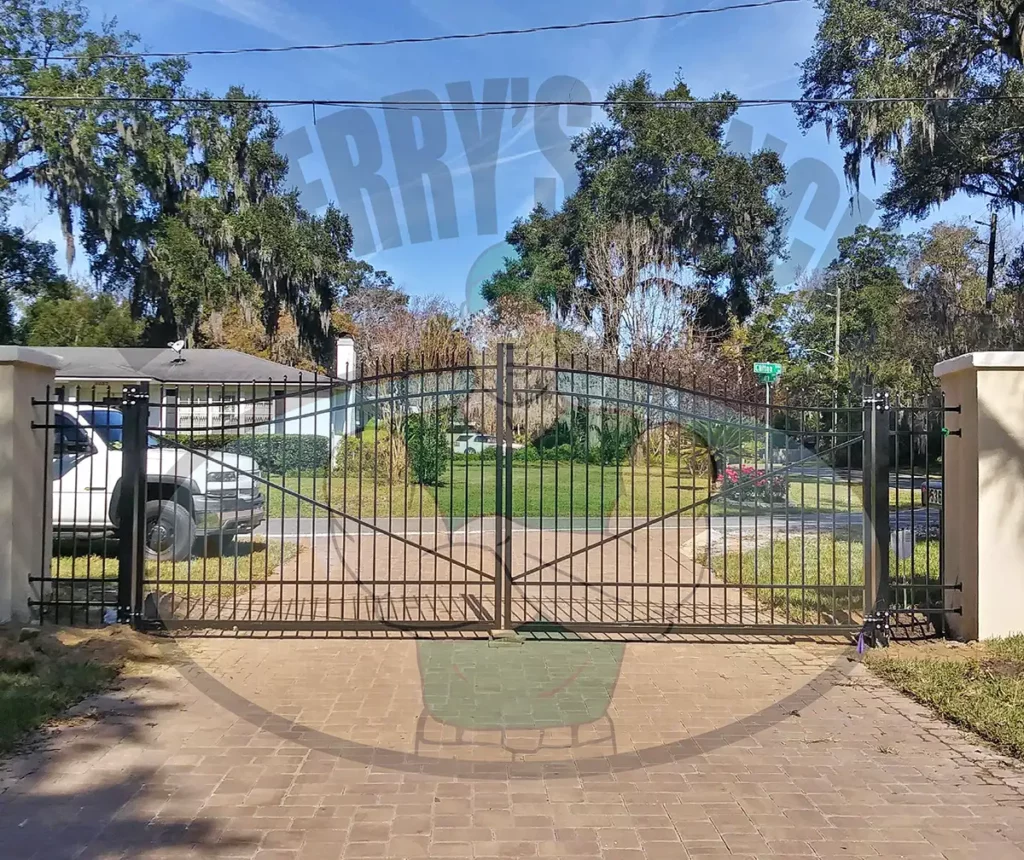 A Drexel aluminum fence features a staggered spear top finish and three horizontal structural support rails, offering an elegant yet simple design with pressed spears and a unique staggered picket pattern, creating depth and dimension to beautifully enhance any outdoor space with a double gate.