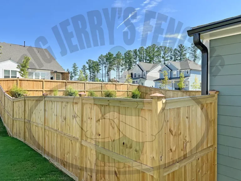 The Glenwood custom wood fence, featuring cap and trim with exterior fascia boards, offers a two-sided finished look, centered pickets with visible posts, and exterior decorative rails that mirror the interior structure, ensuring an aesthetically pleasing, dual-sided design ideal for homes requiring a stylish and visible fencing solution with copper caps.