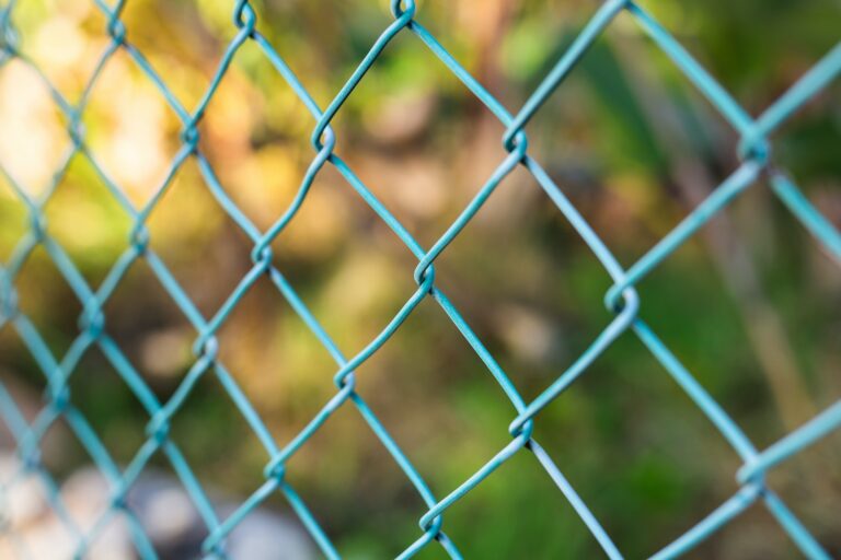 A durable and attractive Green Vinyl Chain Link Fence, offering superior corrosion resistance compared to traditional galvanized chain link fences, with customizable color options to enhance the aesthetic appeal of any property.