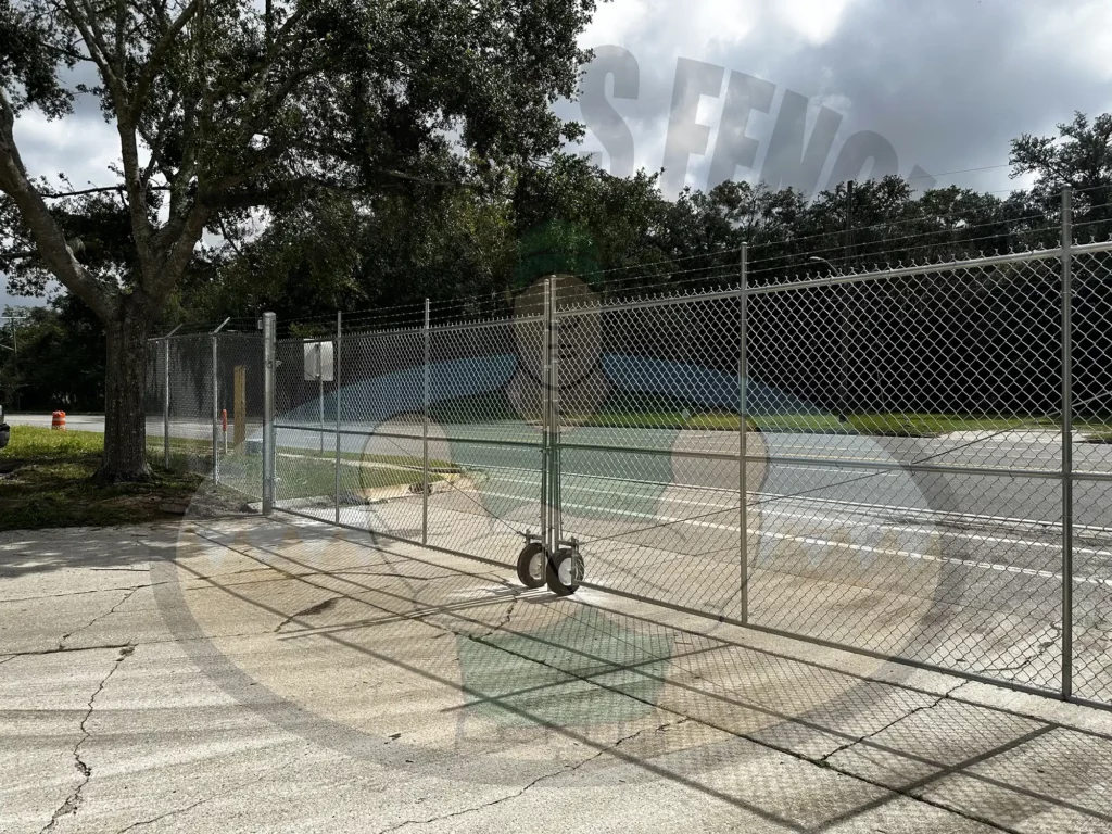 The Galvanized Chain Link fence is a popular and affordable fencing solution known for its endurance and strength. It offers a cost-effective and economical option for residential, commercial, and industrial applications, providing a reliable and budget-friendly property boundary. Commercial Chain Link Gate with Barb Wire